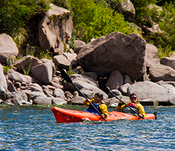 Front view of tourists practicing kayaking in a Cusco lagoon